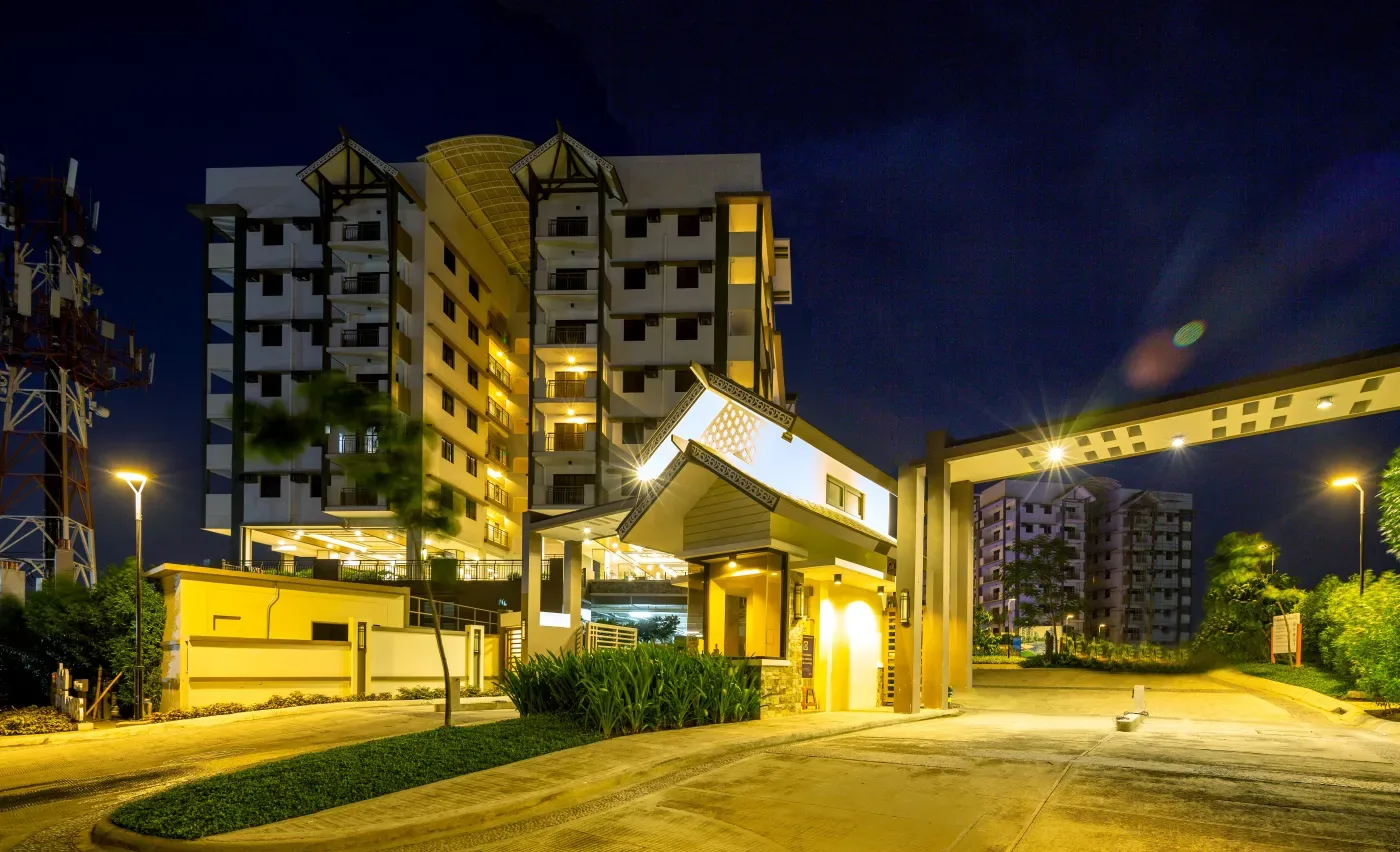 Main entrance gate at Alea Residences lit at night