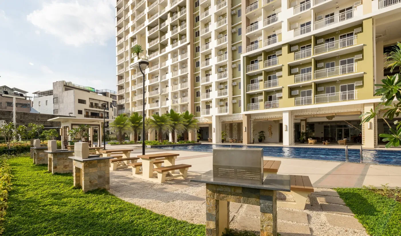 Grill pits and picnic tables on the lawn beside the pool at The Celandine