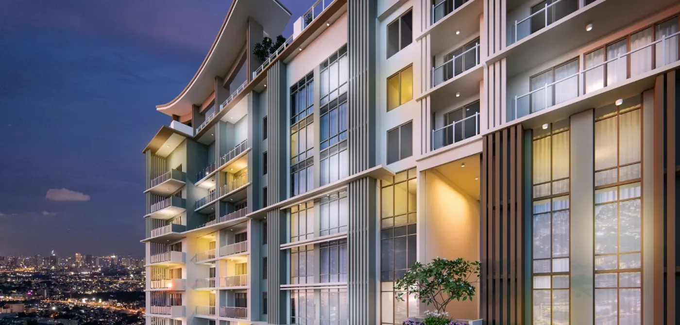 Facade detail of One Delta Terraces at dusk showing balconies and lit units