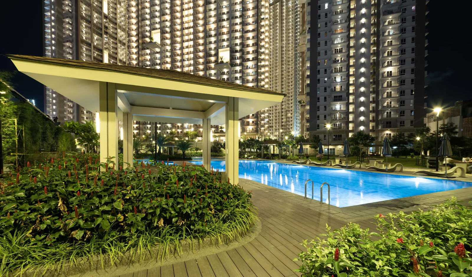The gazebo and lit pool at Prisma Residences after dark
