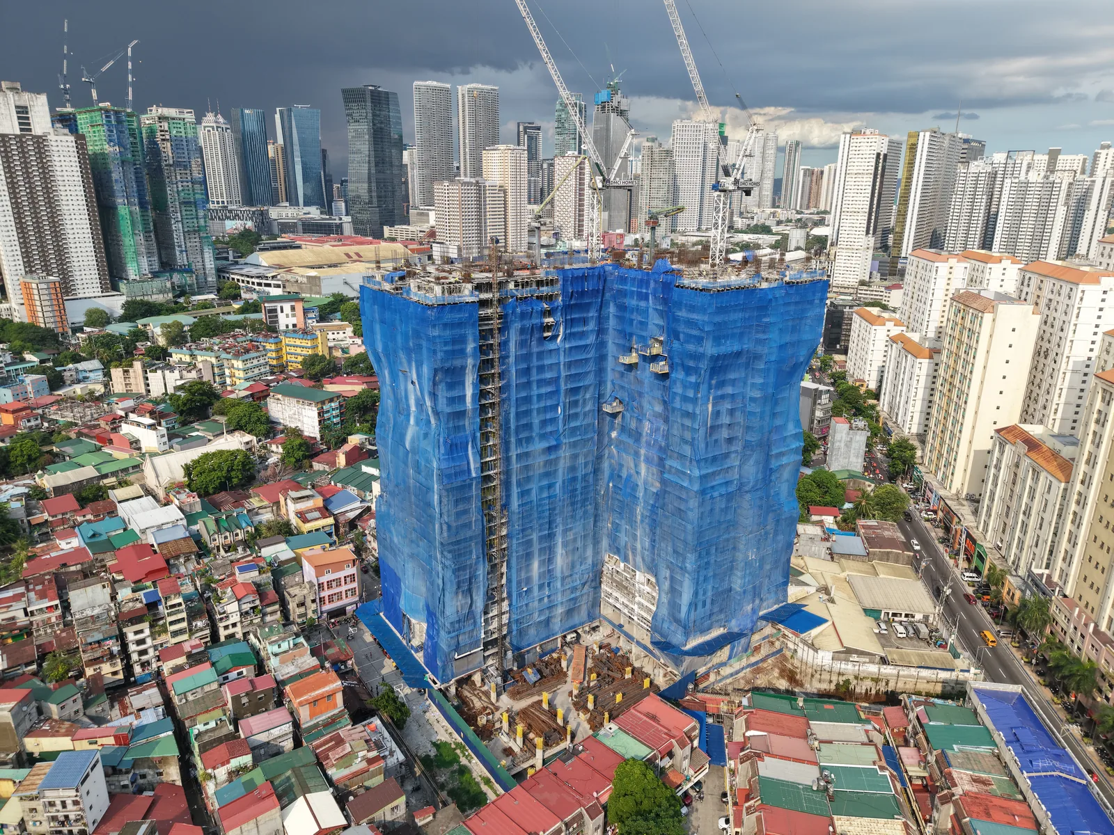 Aerial site photo of Sage Residences, July 2026, with the Ortigas skyline behind